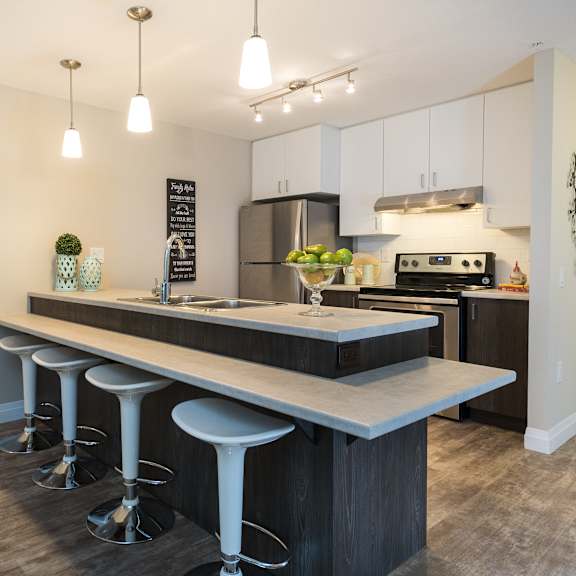 a kitchen with an island and stools