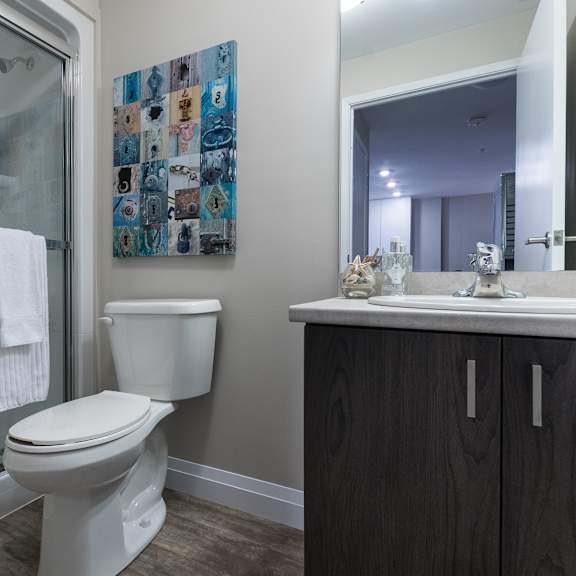 a bathroom with a toilet sink and shower