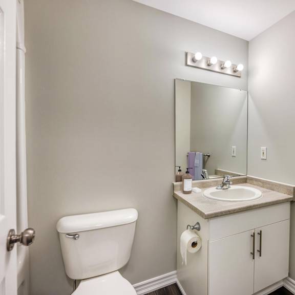 a bathroom with a toilet sink and mirror