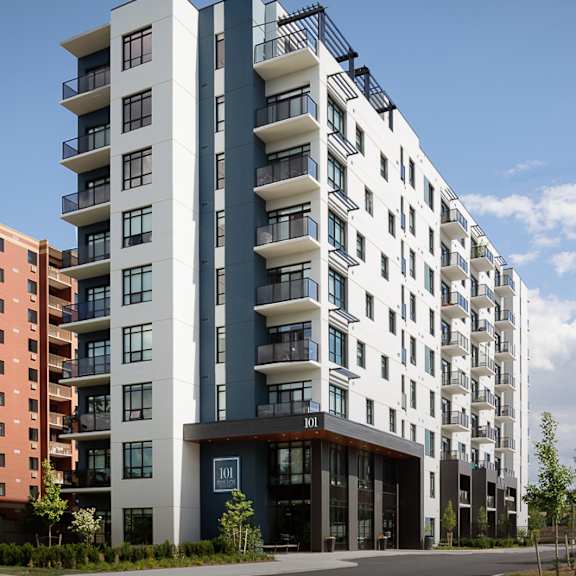 a modern apartment building with balconies on the upper floors.
