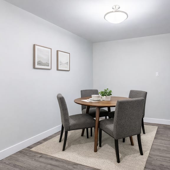 a dining room with a table and chairs.