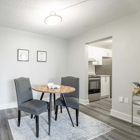 a dining room with a round table and chairs  at platts crossing, london, on, n6h 4p4