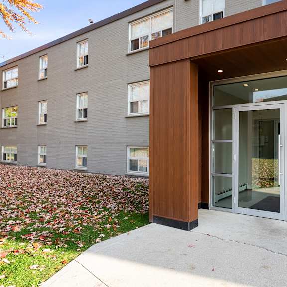 the modern building entrance with a brown wood accents at oakland avenue