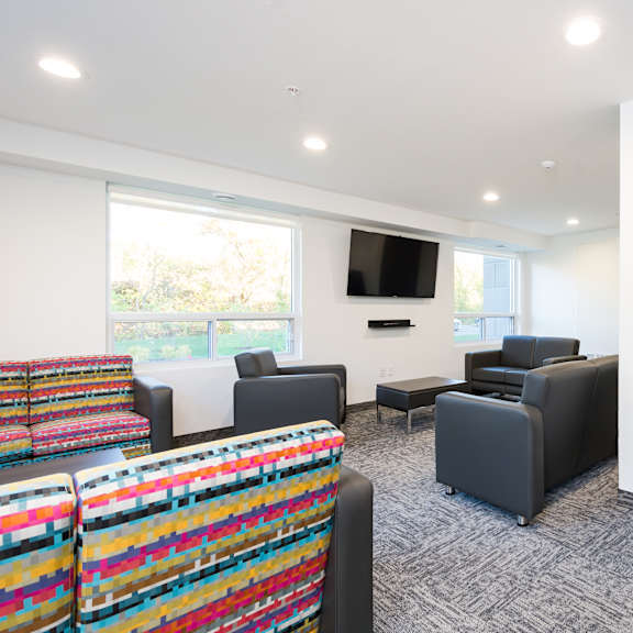 resident lounge with furniture and a flat screen tv