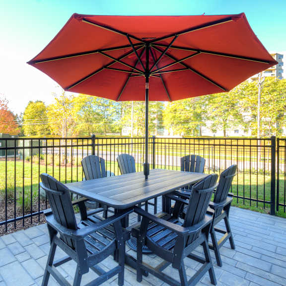 a patio with a table and chairs and an umbrella