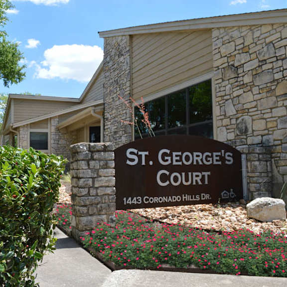 a sign that says st. george's court in front of a building.