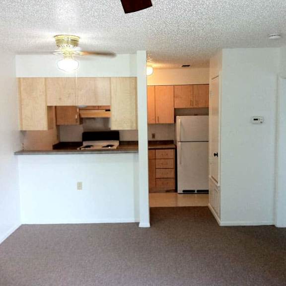 a kitchen with a refrigerator, microwave, and oven.