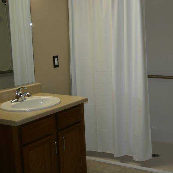 a white shower curtain in a bathroom.
