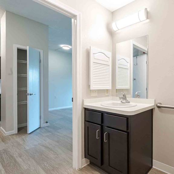 a bathroom with a white toilet, sink, and a mirror.