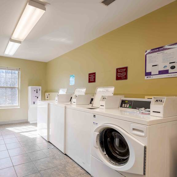 a laundromat with rows of washers and dryers.