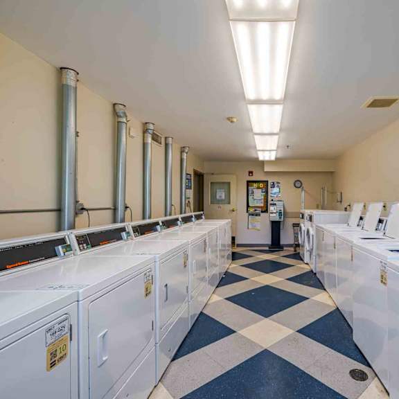 a laundromat with rows of washers and dryers.