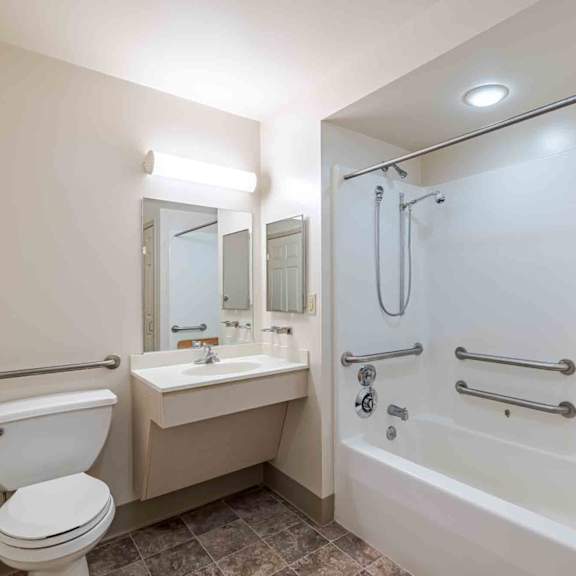 a white toilet sits next to a sink in a bathroom.