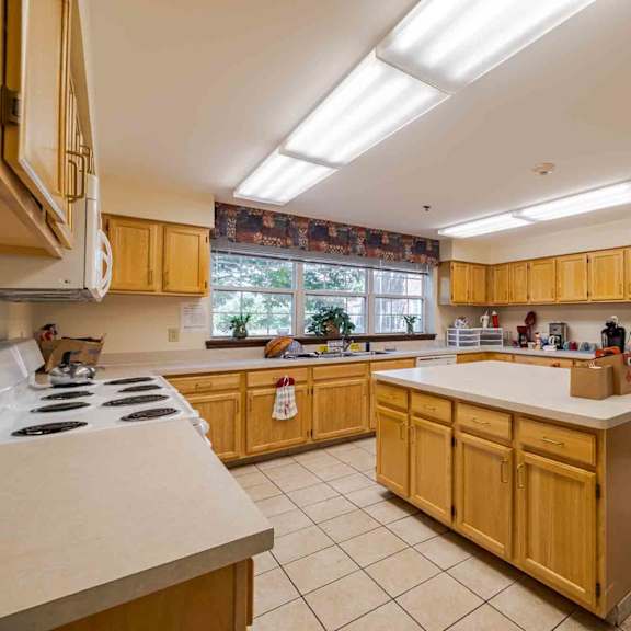 a kitchen with wooden cabinets and a white refrigerator.