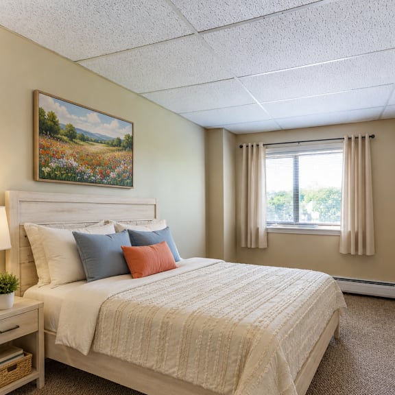 a bedroom with a large bed and a painting on the wall.