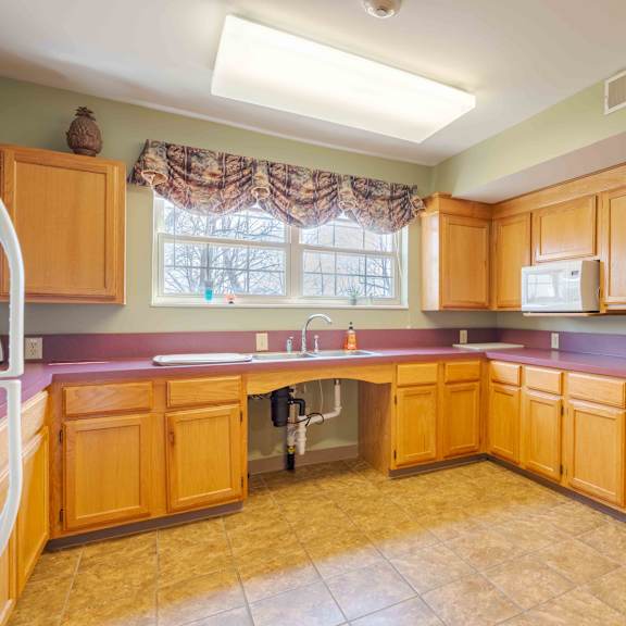 a kitchen with wooden cabinets and a purple counter.