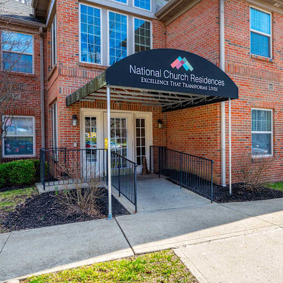 the front of a brick building with a sign that says national church residences.