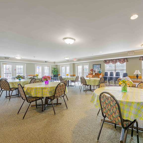 a dining room with tables and chairs set up.