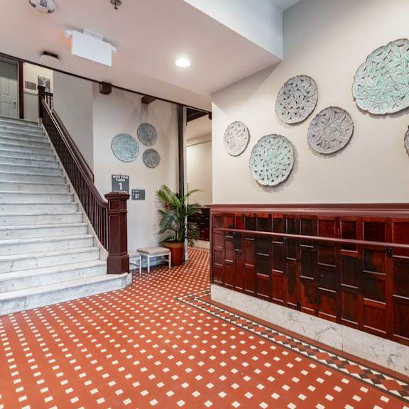 a staircase with a red and white checkered floor.