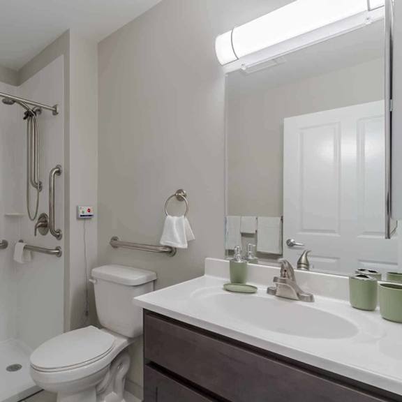 a white toilet is in a bathroom with a white sink.