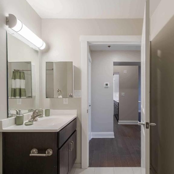 a bathroom with a white sink and a mirror above it.