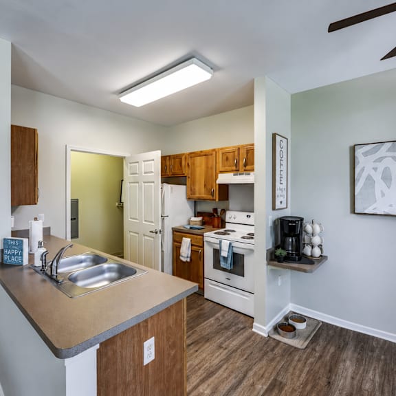 a modern kitchen with a wooden island and stainless steel appliances.