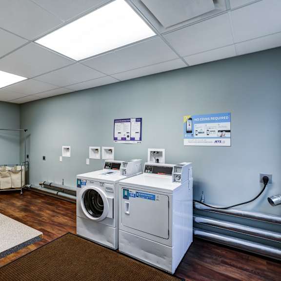 a room with a washing machine and a dryer.