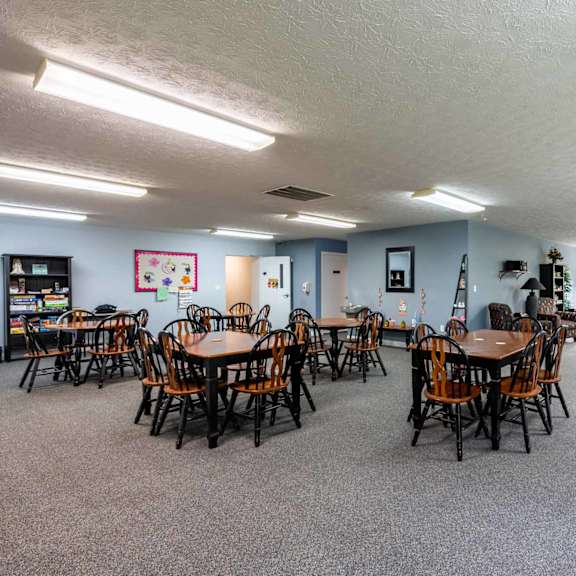 a room with tables and chairs and a couch.