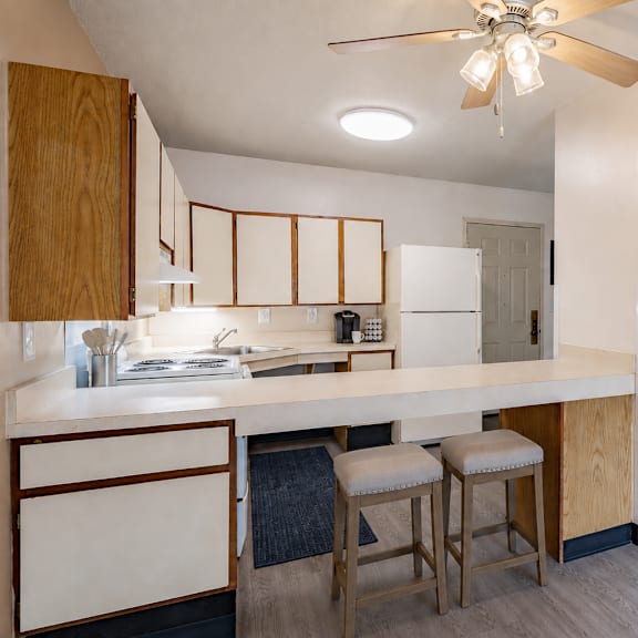 a kitchen with a bar stool and a counter.