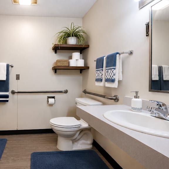 a bathroom with a toilet, sink, and shower curtain.