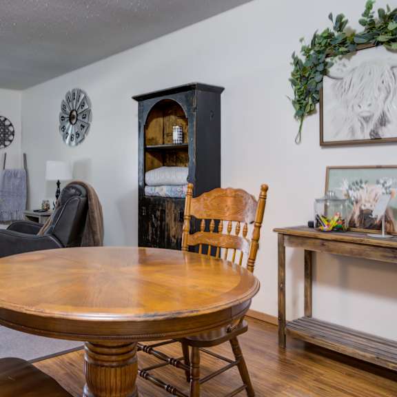 a dining room with a wooden table and chairs.