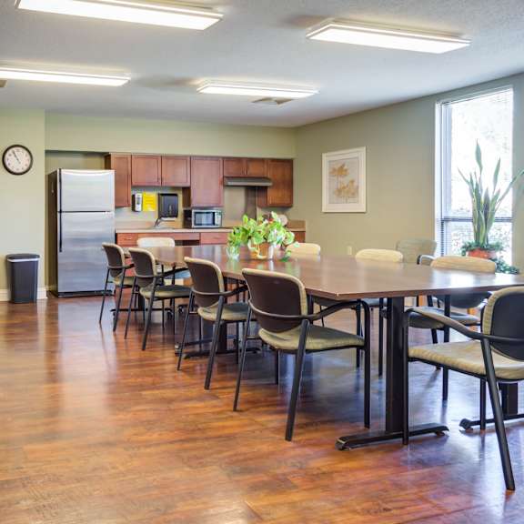 a kitchen with a dining table and chairs.