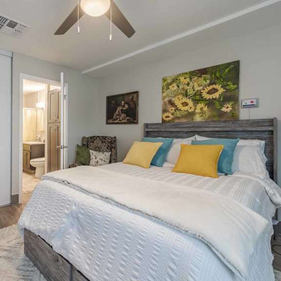 a bedroom with a large bed and a ceiling fan.