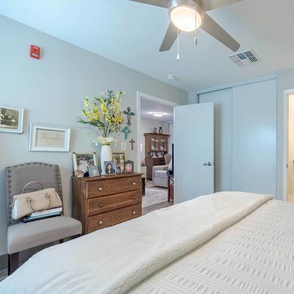 a bedroom with a large bed and a ceiling fan.
