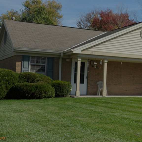 a house with a grey roof and a garage.