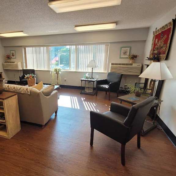 a living room with a couch, chair, and television.