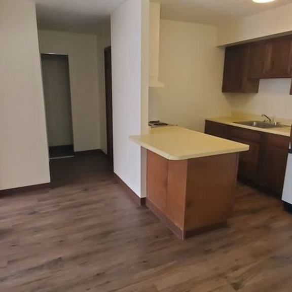 a kitchen with a wooden island in the middle.