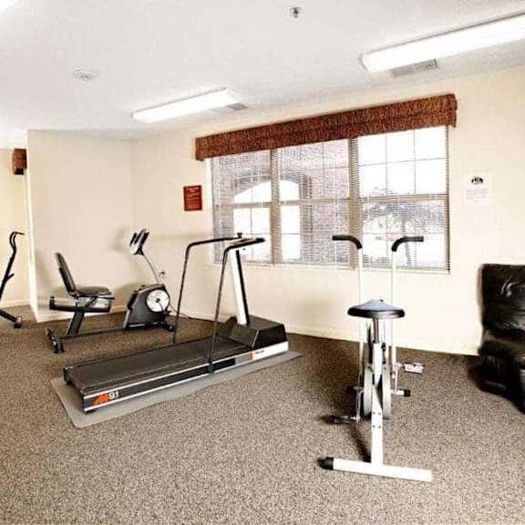 a room with exercise equipment and a window.