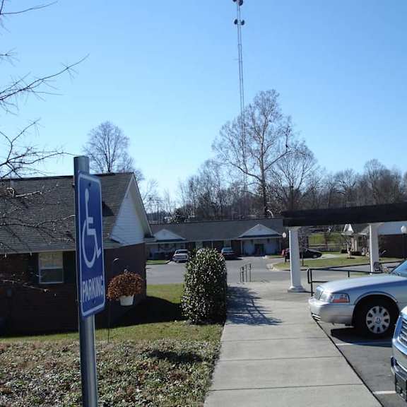 a parking sign is in front of a building.