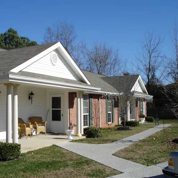 a house with a white front porch and a covered patio.