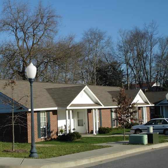a house with a lamp post in front of it.