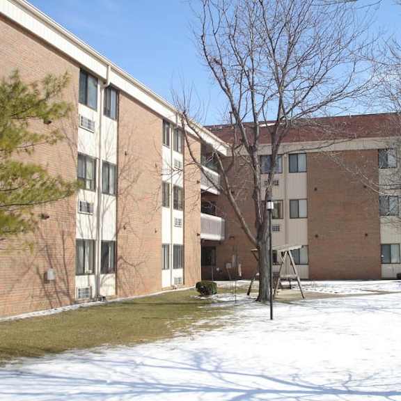 a large building with a playground in front of it.