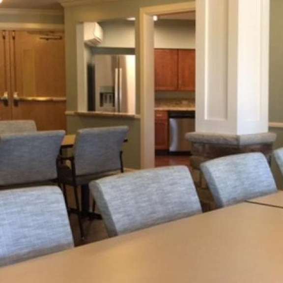 a conference room with a long table and chairs.
