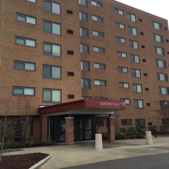 a large brick building with a red awning that says canton place.