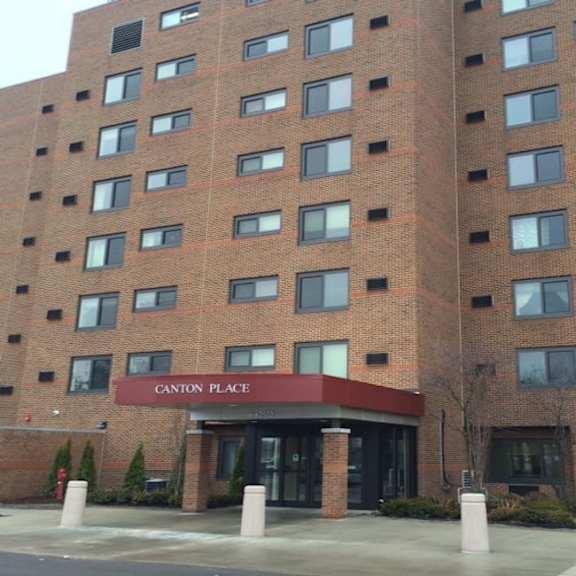 a tall brick building with the words canton place on the entrance.