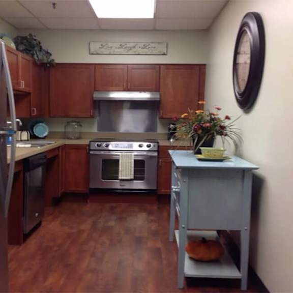 a kitchen with wooden cabinets and a stainless steel refrigerator.