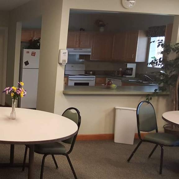 a dining room with a table and chairs.