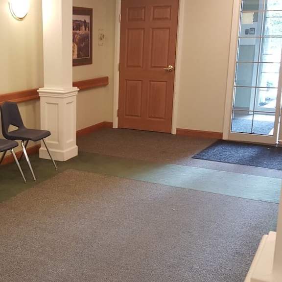 three chairs are lined up against a wall.