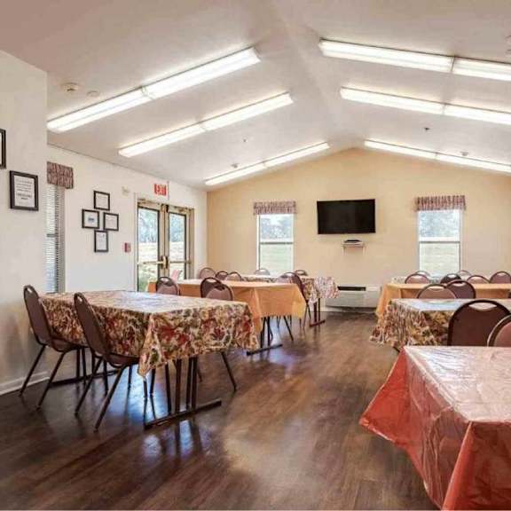 a room with tables and chairs set up for an event.