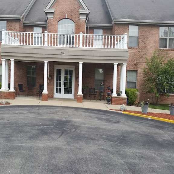 a large brick building with a balcony and a glass door.