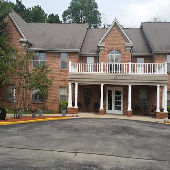 a large brick building with a covered porch.